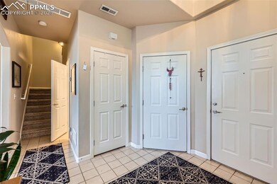 Entryway featuring light tile patterned floors, ba