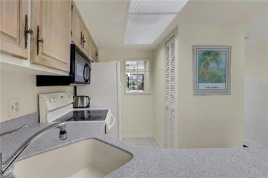 Kitchen featuring light brown cabinets, tile patte