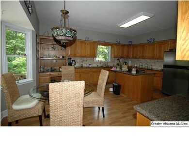 Spacious kitchen with a wonderful wooded view of b