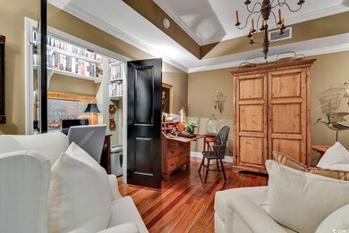 Living room with dark wood-type flooring and ornam