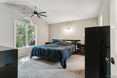 Bedroom featuring carpet flooring, vaulted ceiling