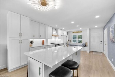 Kitchen featuring wall chimney range hood, sink, a