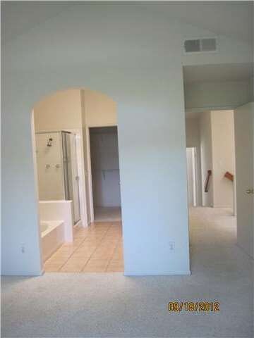 Spacious master suite and bath, leads to large wal