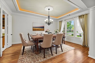 The formal dining room exudes elegance with its tr