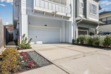 Large, private driveway with a two car garage. Entrance to the home is through the gate on the left.