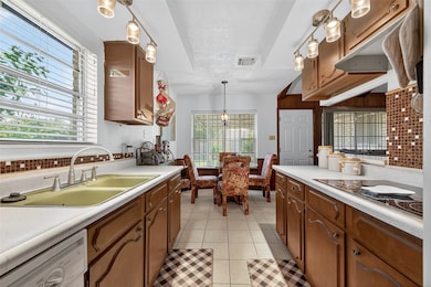 Bright and functional kitchen featuring a dual sink, ample counter space, and seamless flow to adjacent living areas.