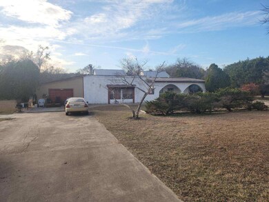 View of front of home with concrete driveway, a f