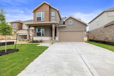 View of front of home with a front yard, an attac
