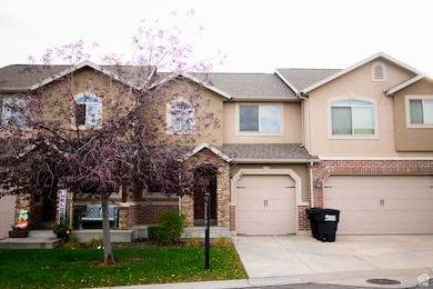 View of front of house with stucco siding, driveway, an attached garage, and a shingled roof