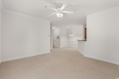 Living room with ceiling fan and crown molding