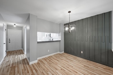 Unfurnished dining area featuring wood finished f