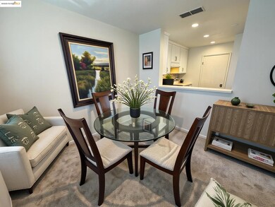 Carpeted dining area with recessed lighting and baseboards