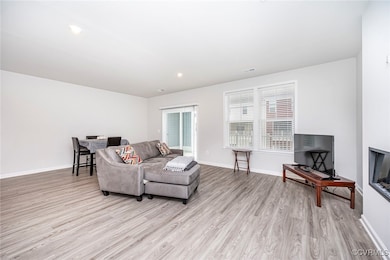 Living room with light wood finished floors and ba
