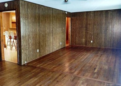 Family-room with beautiful hard wood floors.