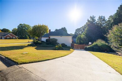 View of property exterior featuring a yard and a chimney