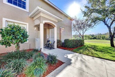 Property entrance with a lawn and stucco siding