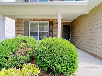 Entrance to property featuring a carport and brick siding