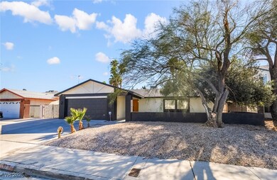 Ranch-style house with stucco siding, driveway, and a garage