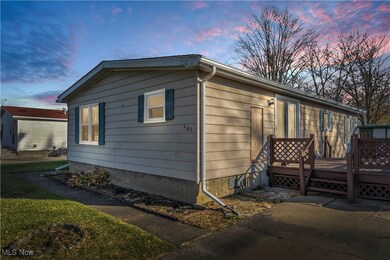 Property exterior at dusk featuring a deck