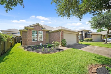 Brick exterior 1-story home with lush landscaping
