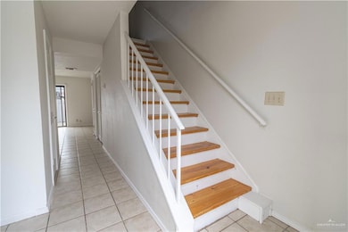 Front entry view to living room and stairway to bedrooms.