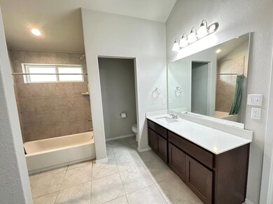 Bathroom featuring shower / bathtub combination with curtain, vanity, light tile patterned flooring, a textured wall, and recessed lighting