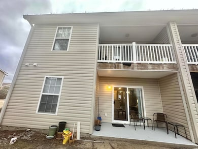 Rear view of house featuring a patio and a balcony