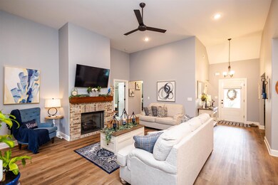 Living room featuring a high ceiling, ceiling fan 