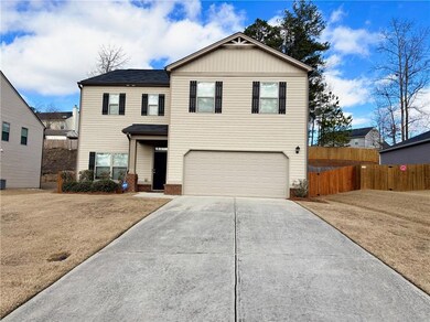Front facade featuring a garage and a front lawn
