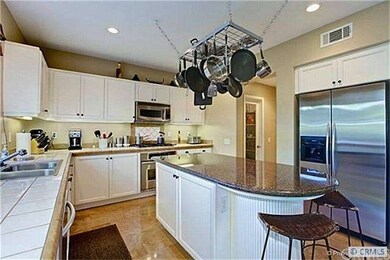 With granite island counter and white Euro cabinet