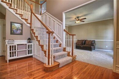 Dramatic two story foyer with decorative wainscoti