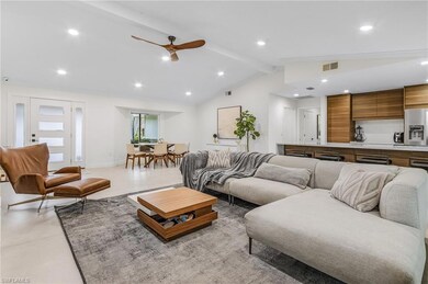 Great room with vaulted ceiling and recessed lighting
