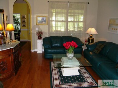 Living room with 12 foot ceilings and hardwood flo