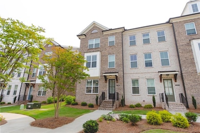 Townhome / multi-family property with brick siding