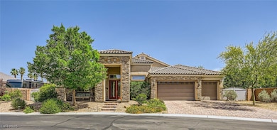 View of front of house featuring stone siding, a g