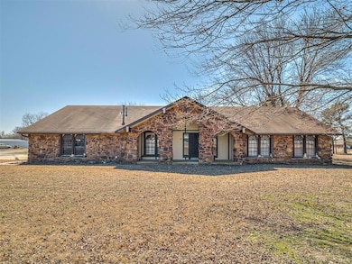 View of front of home with a shingled roof, stone 