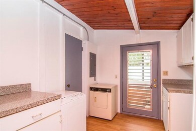 The laundry space also serves as the access to the