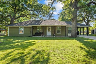 Ranch-style home with a front yard, covered porch,