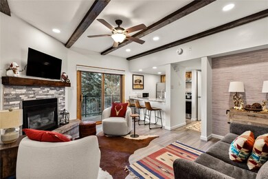 Living room with wood-type flooring, ceiling fan,