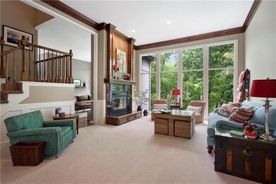 Formal living room shows see-through fireplace, wo