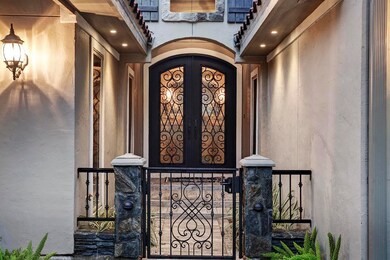 Beautiful iron gate leading to the front entry of the home.