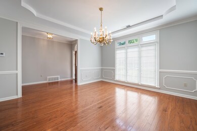Elegant room with large window, trayed ceiling and