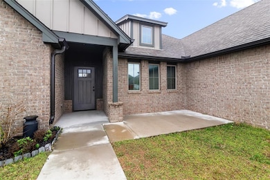 Property entrance with brick siding, board and bat