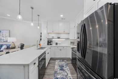 Kitchen with dark wood-type flooring, white cabine