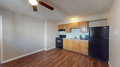 Kitchen with dark wood-style flooring, a sink, a c