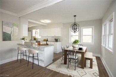 Kitchen with light hardwood / wood-style floors, pendant lighting, and white cabinetry
