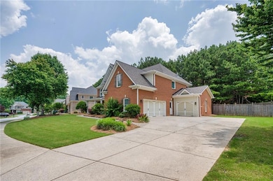 View of front of home with brick siding, concrete driveway, and an attached garage
