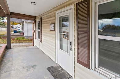 View of exterior entry with covered porch