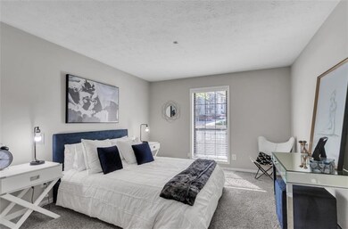 Carpeted bedroom featuring a textured ceiling