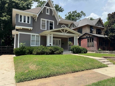 View of front of home with a porch and a front lawn